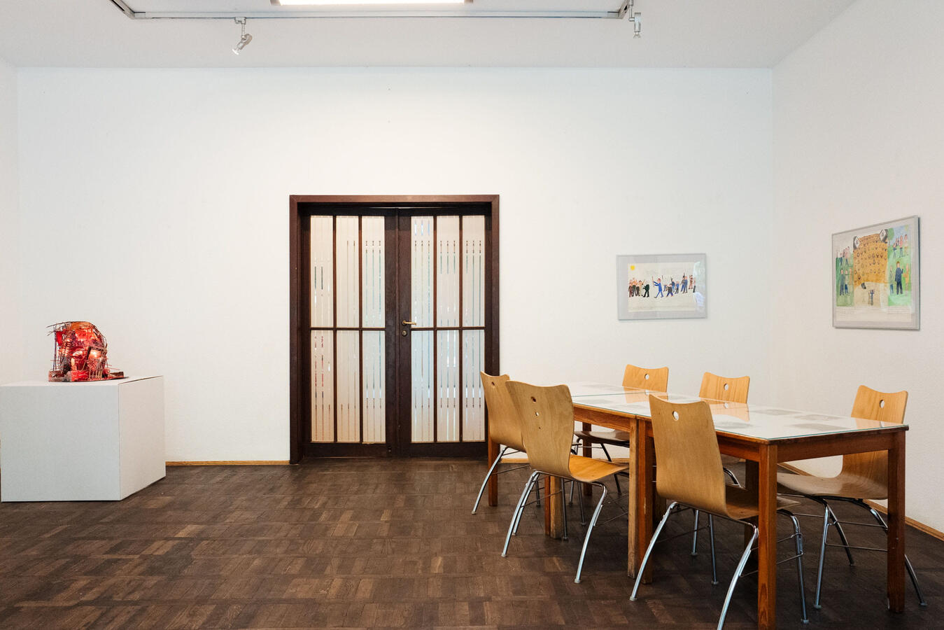 links: Skulptur von Michael Pleißner, Tisch: Zeichungen von Abuzze von Schandel, Wand: Bilder von Anne-Katrin Störmer, Foto: Maximilian Koppernock